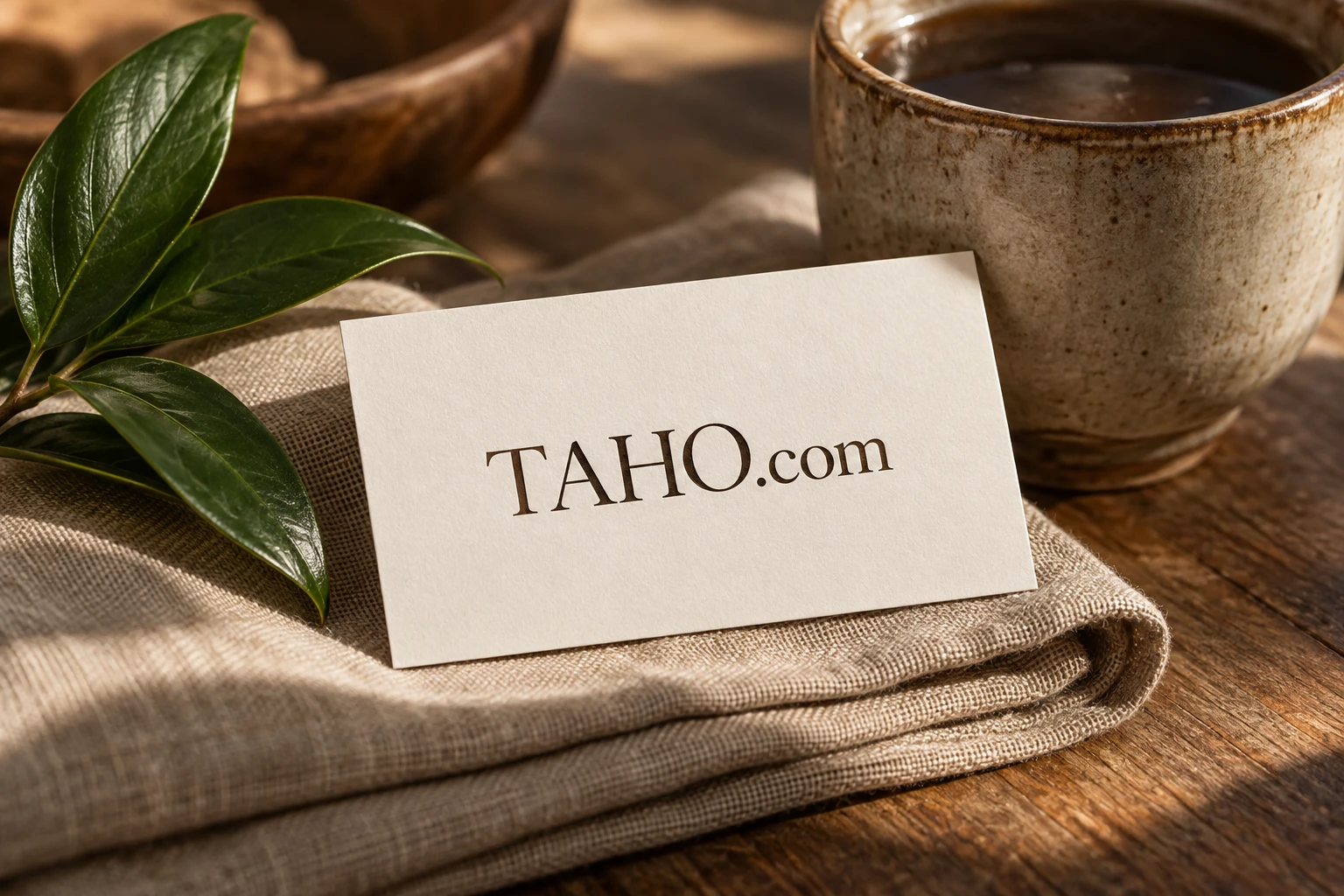 TAHO.com printed on a warm paper brand card